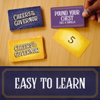 Card game with text on cards and a hand holding one, on a wooden surface. cheers to the governor. family game, party game, big groups.