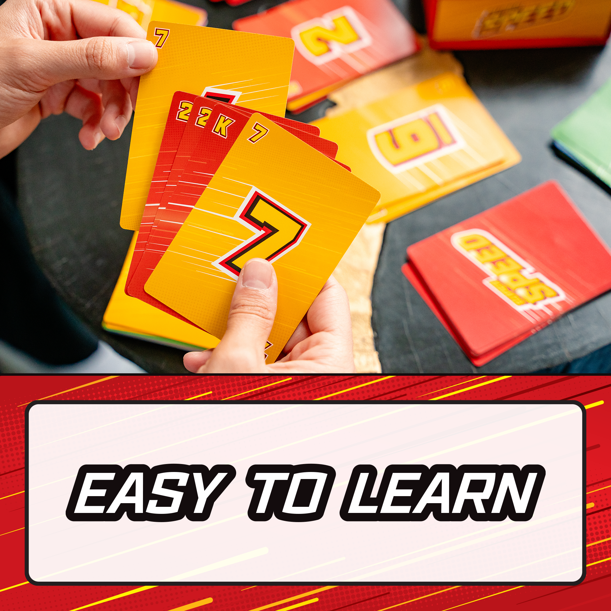 A close-up of hands holding a fan of colorful educational cards, with more cards scattered on a dark tabletop. A large text banner at the bottom reads 'EASY TO LEARN'. speed family fun card game