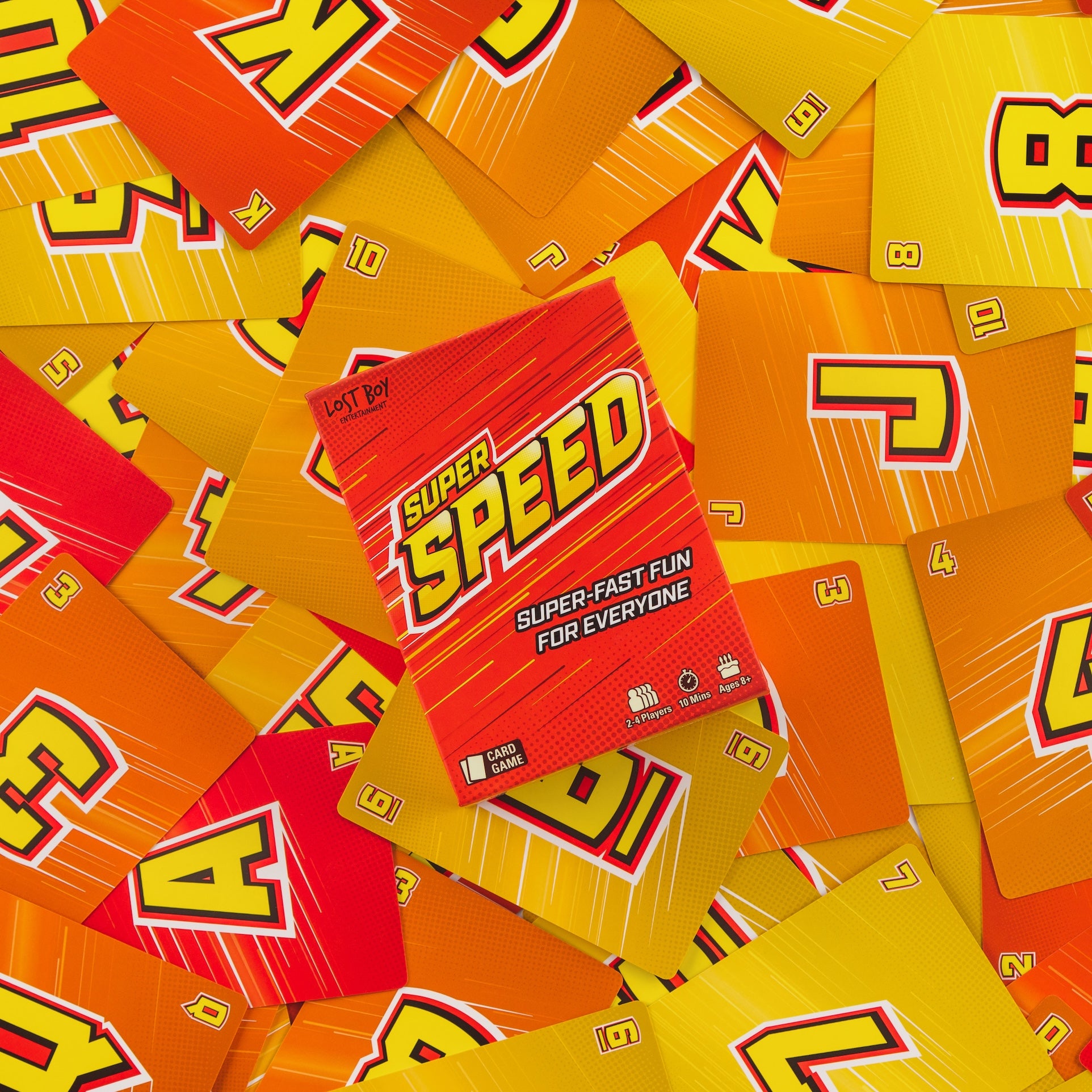 A red and orange game box labeled 'SUPER SPEED' is surrounded by scattered matching yellow and orange cards with large stylized letters, creating a bold, energetic layout on a white background. speed family fun card game