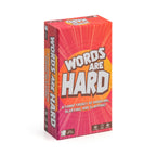 The product image shows the packaging of 'Words Are Hard', a board game designed for 2-4 players aged 14 and up. The box is predominantly red with images of the players engaged in playful activities like babbling, blurring, and slapping.