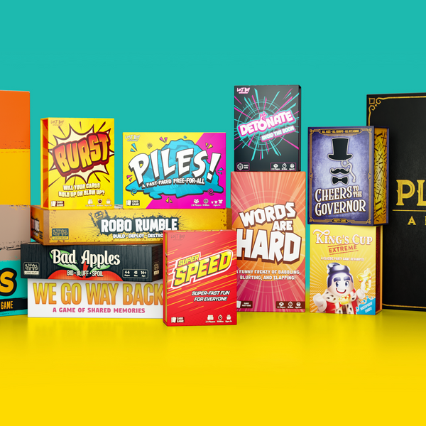 A collection of pirate-themed card games and a board game set arranged in a row against a split yellow and teal background. Visible products include Kangaroo Toss, Piles!, Hard, and Plunder: A Pirate's Life.